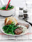 Beef steak with dill sauce, baked potatoes and green beans