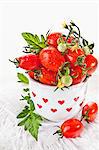 Cherry tomatoes in a vase decorated with red hearts