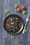 Black squid ink pasta with tomatoes and basil