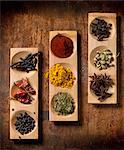 Various spices in wooden dishes (seen from above)