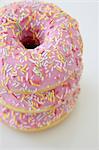 Pink iced doughnuts with sugar sprinkles