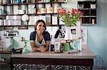 Bakery owner leaning over counter