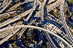 Aerial view of sunlit curved flyovers and highways, Los Angeles, California, USA