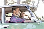 Heterosexual couple in car together, smiling