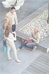 Businessman and women chatting informally on hotel terrace