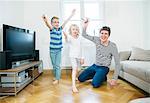 Father and children having fun with paper airplanes