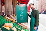 Greengrocer's Shop, grocer holding price tag