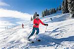 Ski holiday, Group of skiers carving downhill, Sudelfeld, Bavaria, Germany