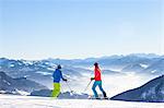 Ski holiday, Skiers overlooking mountain scenery, Sudelfeld, Bavaria, Germany