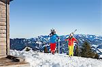 Ski holiday, Skiers on mountain peak, Sudelfeld, Bavaria, Germany