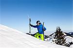 Ski holiday, Skier hiking uphill, Sudelfeld, Bavaria, Germany