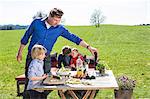 Family having barbecue in the meadow