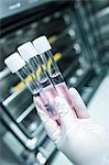 Scientist holding three test tubes with liquids