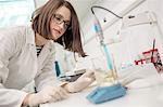 Female scientist doing experiment in laboratory