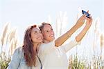 Friends pausing for selfie during road trip