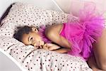 Girl lying on bed in tutu