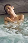 Woman soaking in spa pool