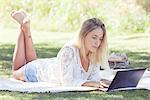 Woman using netbook outdoors