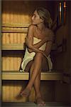 Woman sitting in sauna