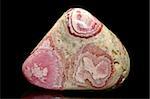 Sample of a beautiful natural Rhodochrosite gemstone speciment isolated on black background