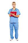 Isolation of a smiling medical practitioner posing with a clipboard, white background.