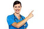 Doctor pointing away with her index finger. Copy space area.