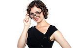 Glamorous woman adjusting her spectacles isolated over white.