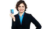Attractive woman holding up credit card to the camera, business concept.