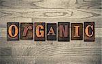 The word "ORGANIC" theme written in vintage, ink stained, wooden letterpress type on a wood grained background.