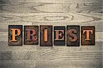 The word "PRIEST" theme written in vintage, ink stained, wooden letterpress type on a wood grained background.