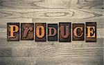 The word "PRODUCE" theme written in vintage, ink stained, wooden letterpress type on a wood grained background.