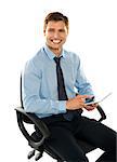 Seated young executive using tablet pc isolated against white