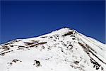 Winter mountains and ski slope in little snow year. Caucasus Mountains, Georgia. Ski resort Gudauri.