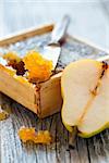 Honey comb and ripe pears on old wooden table.