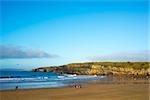 people enjoying a walk on Ballybunion beach one bright winters day