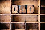 The word DAD written in vintage wooden letterpress type in a wooden type drawer.