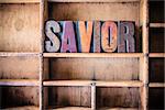 The word SAVIOR written in vintage wooden letterpress type in a wooden type drawer.