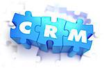 CRM - Customer Relationship Management - White Word on Blue Puzzles on White Background. 3D Render.