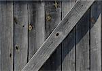 OId gray weathered timber wood barn door background