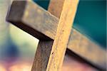 A macro closeup of a wooden Christian cross laying at an angle.