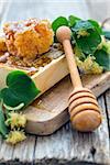 Flowers of lime and honey comb on an old table.