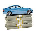 Car on bundle of money on isolated white background