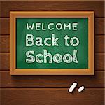 Blackboard with text "back to school" on wooden wall