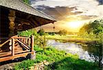 Wooden bathhouse near lake at the sunset