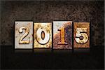 The word "2015" written in rusty metal letterpress type on a dark textured grunge background.