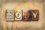 The word "BODY" written in rusty metal letterpress type on a crumbled aged paper background.