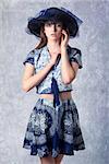 fashion shoot of pretty woman with lovely summer style, wearing hat, elegant skirt and top and looking in camera