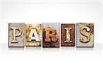 The word "PARIS" written in rusty metal letterpress type isolated on a white background.
