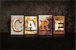 The word "CARE" written in rusty metal letterpress type on a dark textured grunge background.
