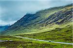 Traffic on Road through Scottish Highlands near Glencoe, Scotland, United Kingdom